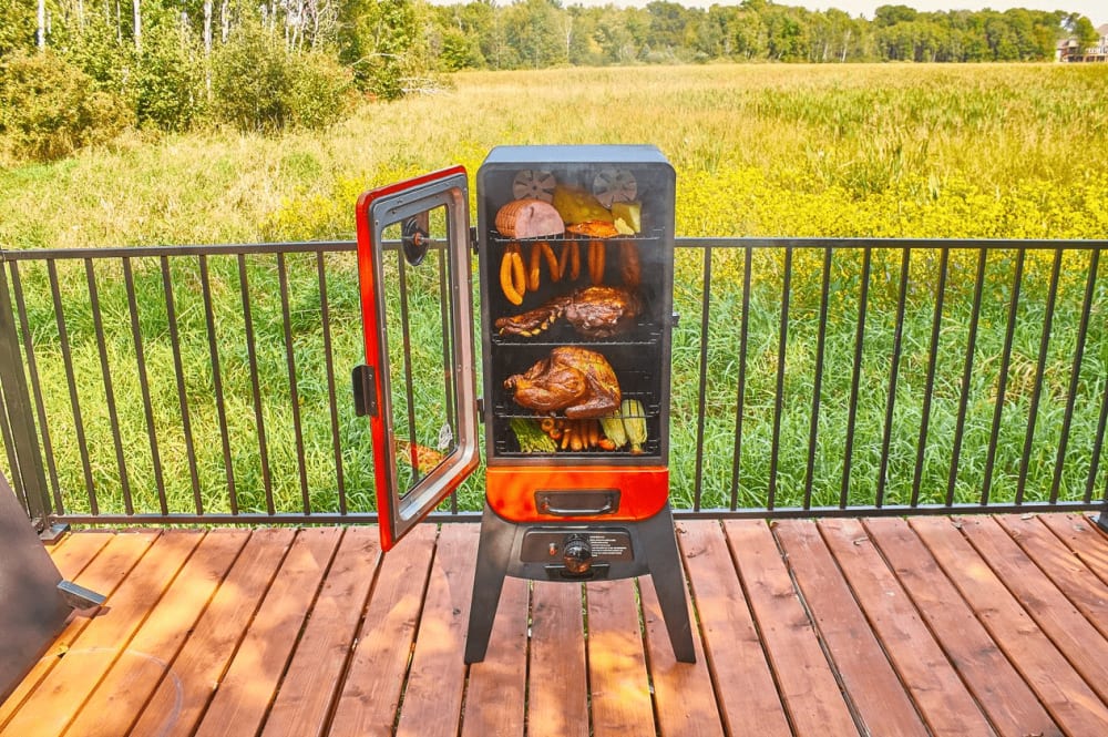 Pit Boss 10773 31 Inch Freestanding Vertical Gas Smoker with 720 Sq. In. Cooking Area 12 500 BTU Output Dual Valve Burner System 4 Porcelain Coated Racks Control Knob Piezo Ignition 2 Stainless Steel ...
