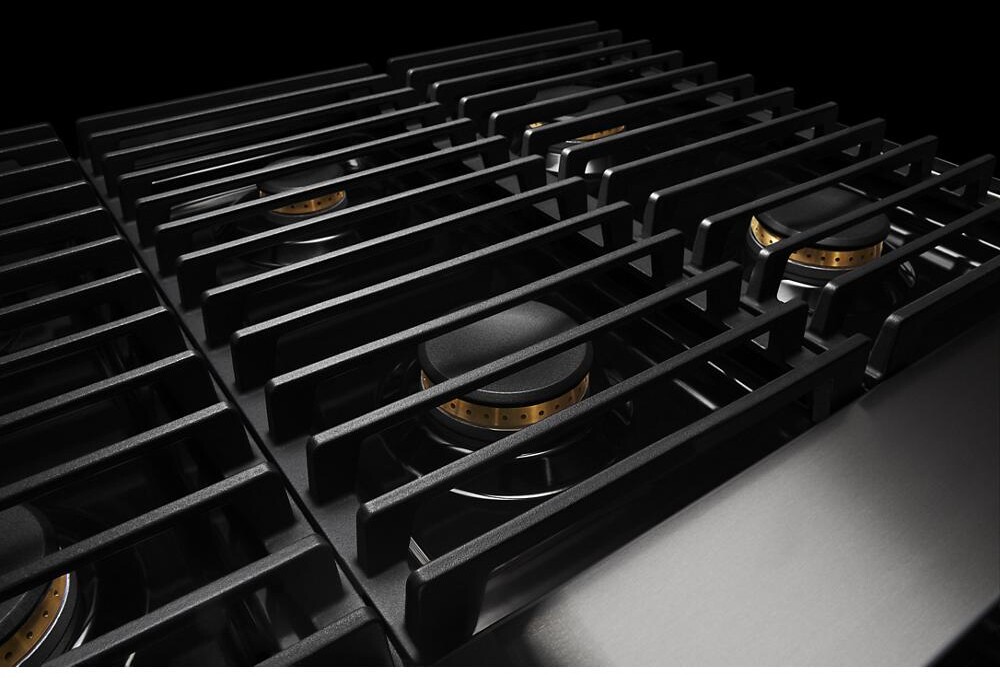 Close-up of cast-iron style cooktop grates over gas burners