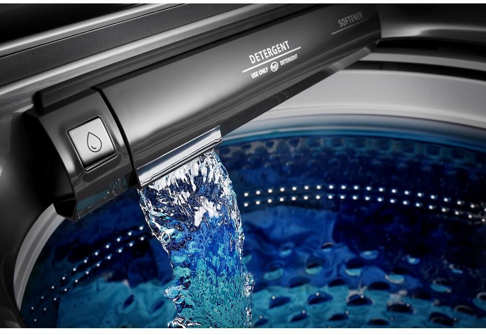 Built-in water faucet pouring water into the washer tub